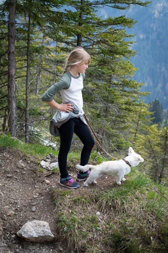 Pic 5 a child and her white dog on a hike